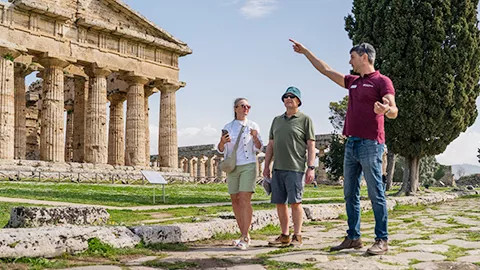 A Tour Leader guiding guests through ancient Italian ruins.