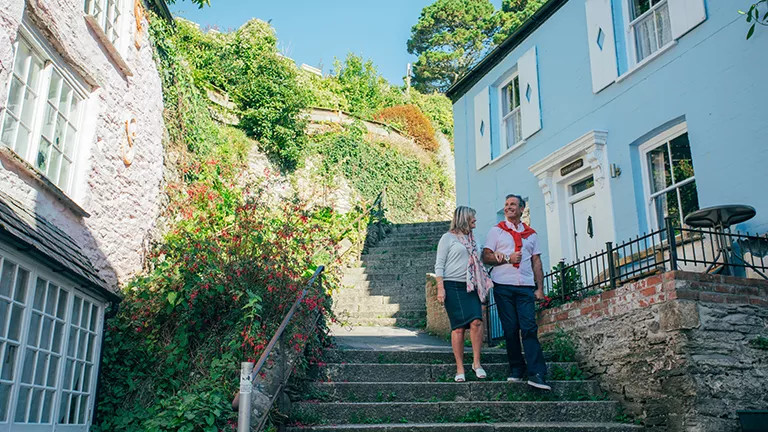 Guests enjoying a walk thought a Cornish village.
