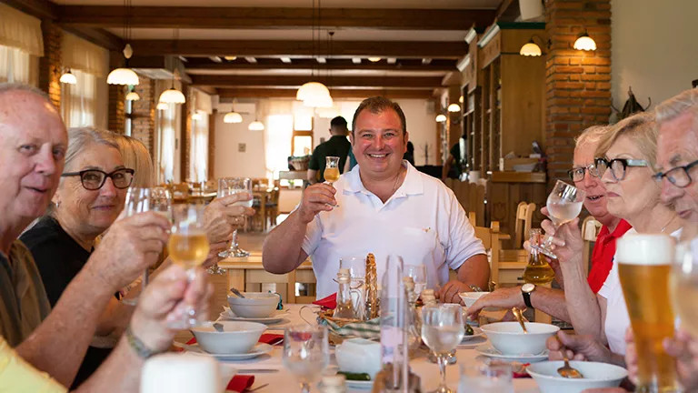 Guests enjoying a meal with the Tour Leader in Romania.