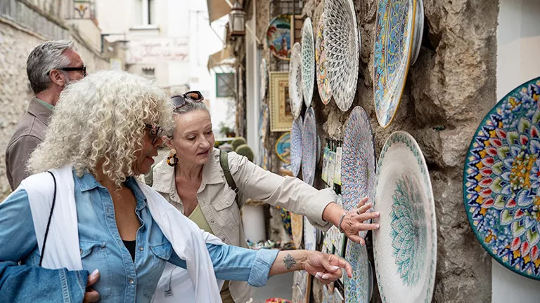 Guests perusing souvenir shops in Italy.