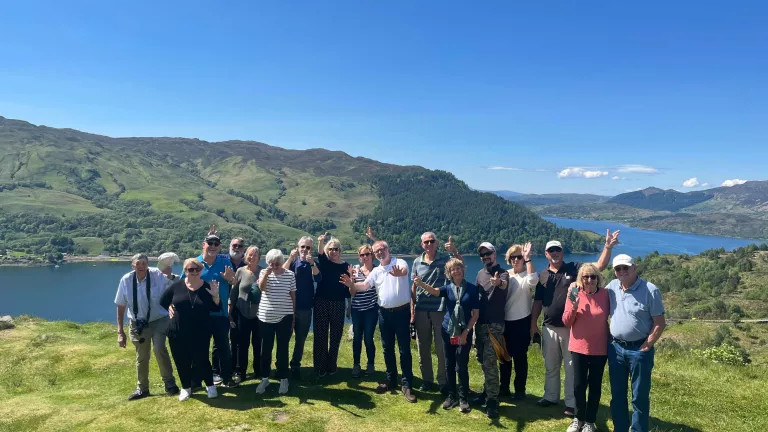 A tour group taking a photo during the a Scottish Journey tour
