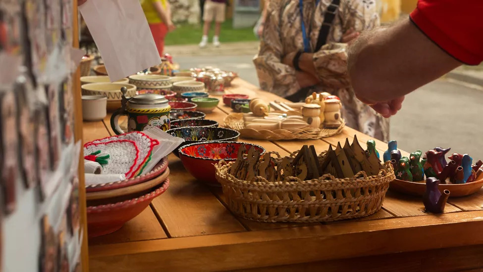 A table full of traditional handmade goods at a market.