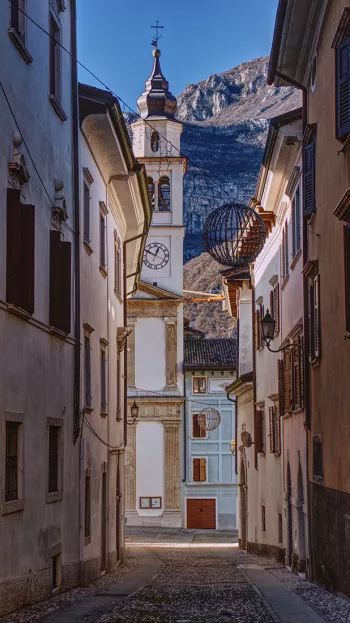 Shade envelops the streets of Trento on a sunny day.