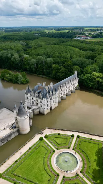 An overhead view of the Château de Chenonceau, a Chateau spanning the River Cher.