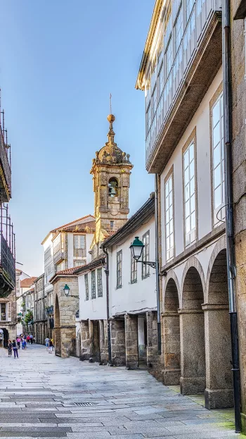 A view of the streets of Santiago Spain, with the cathedral towers in the background.