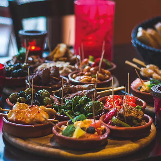 Plates of spanish tapas on a table.