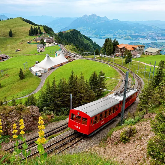 A small tram winds through the massif of Mt Rigi in the Swiss Alps.