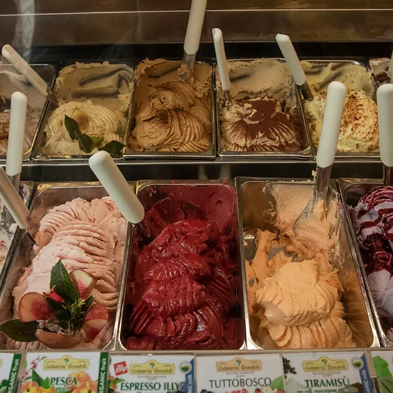 Tubs of Italian Gelato on display, each one containing a different and exciting flavour.