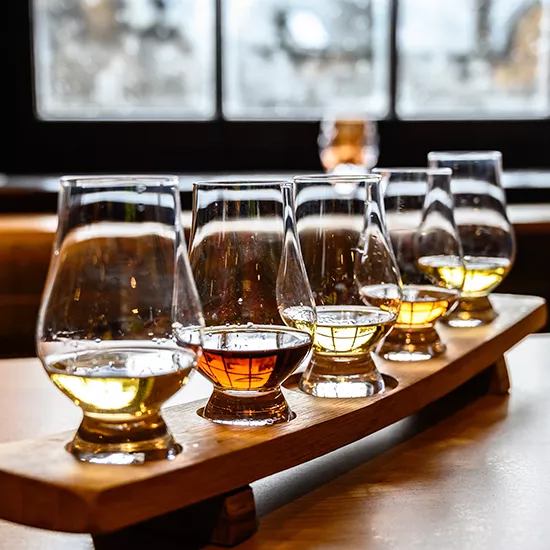 A tasting rack of different whiskies during a Highland Whiskey tasting experience.